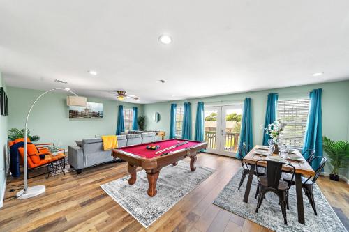 a living room with a pool table in it at Elevated Stay Near Pier, Beach BBQ WiFi Games in Galveston