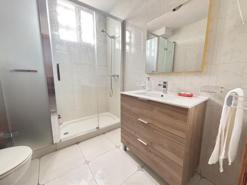 a bathroom with a shower and a sink and a toilet at Desconectaengalicia El Pescador, vistas al puerto, 200m playa in Portonovo