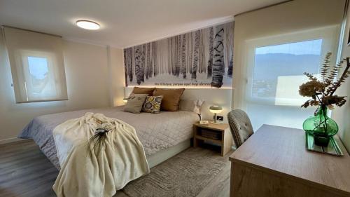 a bedroom with a bed and a desk and a window at LAS QUINTAS DE BRICIA 6-B in Posada de Llanes