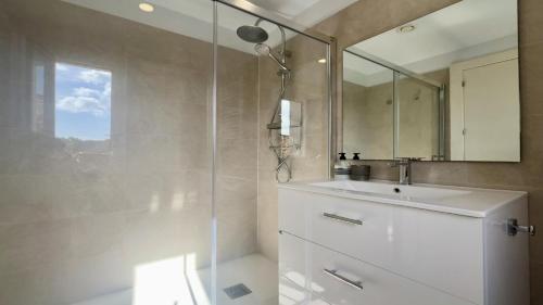 a bathroom with a shower and a sink and a mirror at LAS QUINTAS DE BRICIA 6-B in Posada de Llanes