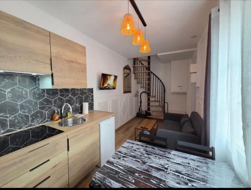 a kitchen and a living room with a couch at White House in Étretat