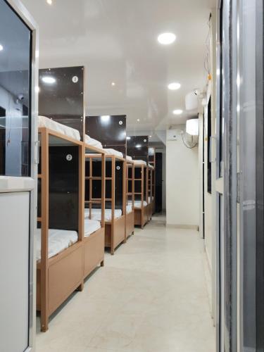 a row of bunk beds in a room at Viresh Cottage in Solapur
