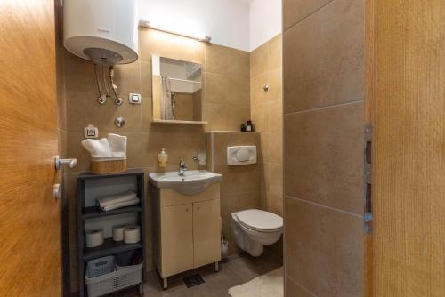 a small bathroom with a toilet and a sink at My Nest Accommodation in Privlaka