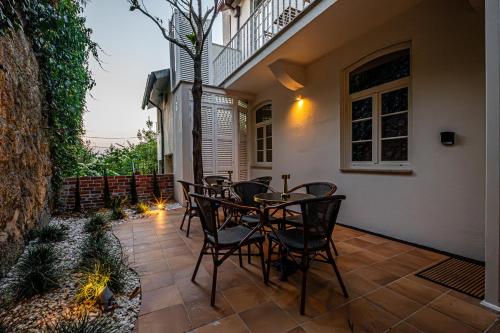 a patio with a table and chairs on it at Celtic Lodge - Guest House in Viseu