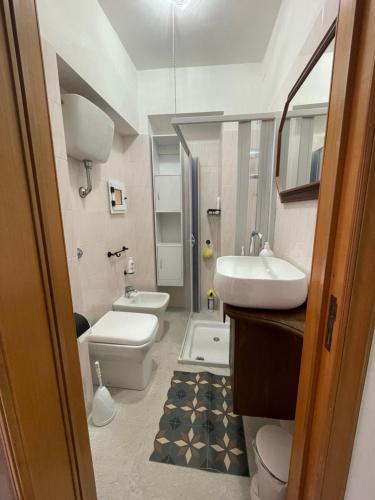 a bathroom with a sink and a toilet and a sink at Il Vicoletto in Biccari