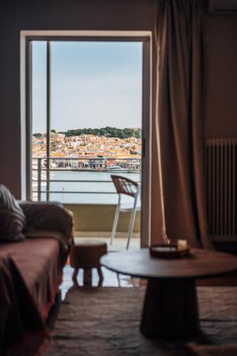 a living room with a view of a city from a window at Aether View Premium Views in Central Mytilene in Mytilene