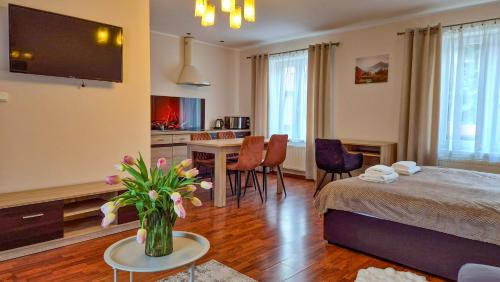 a bedroom with a bed and a dining room with a table at W Samiuśkim Centrum in Szczyrk