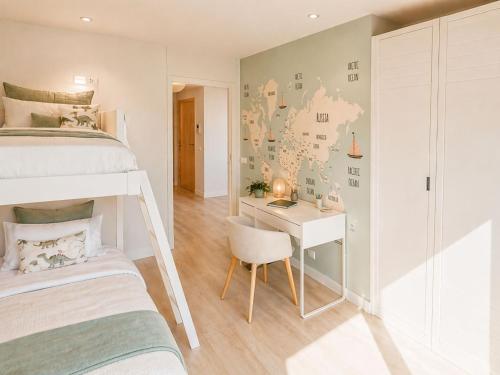 a small bedroom with a bunk bed and a desk at RenTenerife Elim Ocean in La Tejita