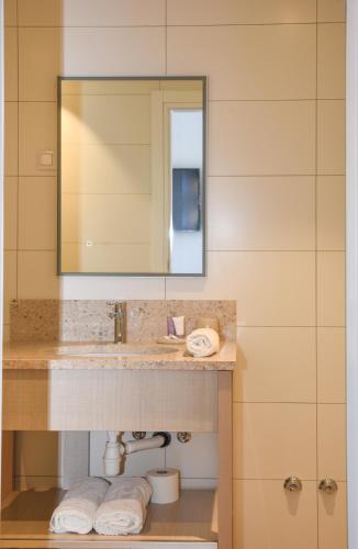 a bathroom with a sink and a mirror at Šangulin Palace M in Biograd na Moru
