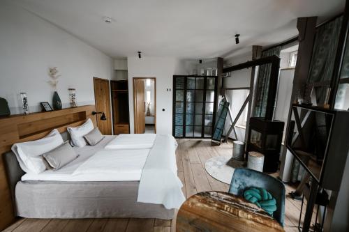a bedroom with a large white bed and a chair at Apart Hotel Wasserturm in Bad Segeberg