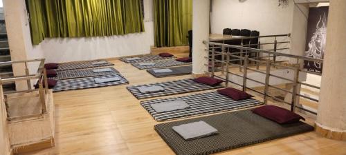 a room with a row of mats on the floor at Himalayan siddh yog ashram in Rishīkesh