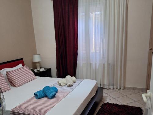 a bedroom with a bed with two towels on it at Kerkis View House-Garden View in Karlovasi