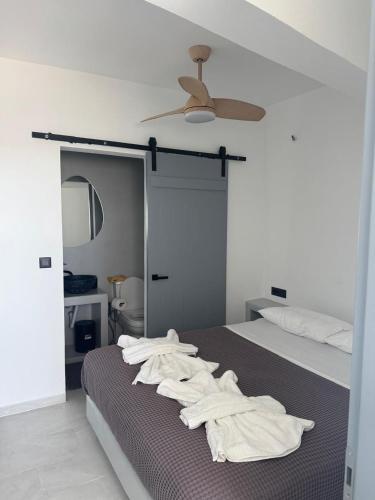 a bedroom with a bed with white towels on it at MIRA house in Ios Chora