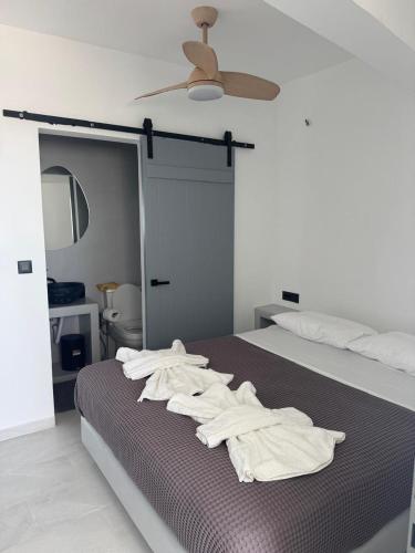a bedroom with a bed with white towels on it at MIRA house in Ios Chora