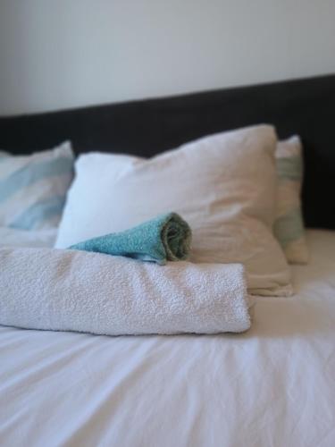 a pile of towels on a bed with pillows at Heinamaa Lodge with sauna in Lammasküla