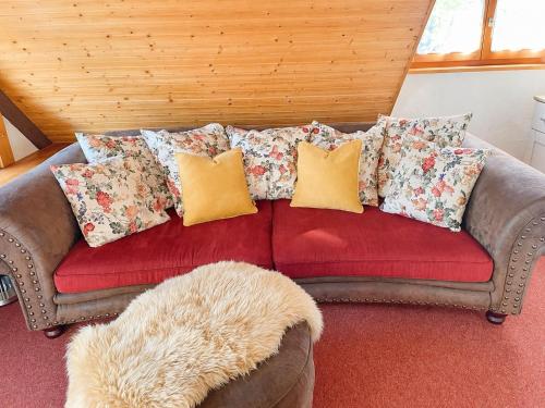 a couch with many pillows on it in a room at Ferienhaus mit 3 Apartments - Belle Apartment - Top-Lage, Sauna, HS-Card in Feldberg