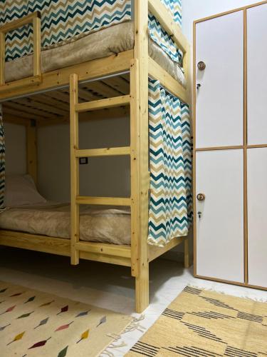 a bunk bed in a room with a doorway at Zalooma House I Beachfront Hostel Dahab in Dahab