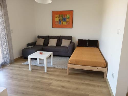 a living room with a couch and a table at Casa da Quinta T1 in Mafra