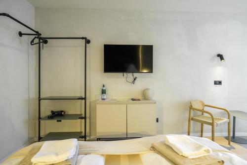 a bedroom with a bed and a tv on the wall at Boutique Hotel an der Mosel - ehemalig Hotel Kreuter in Koblenz