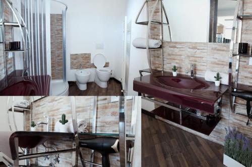 a bathroom with a sink and a toilet at Escape Anzio- intero appartamento in Anzio