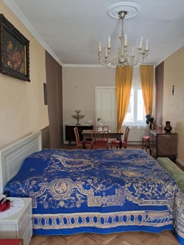 a bedroom with a large bed and a dining room at Guest House Ucha in Mtskheta