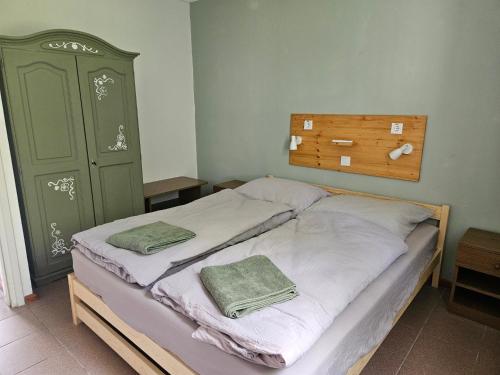 a bedroom with a bed with two towels on it at Dömös Danu Kemping in Dömös