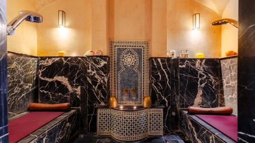 a bathroom with a shower with black marble at Zalagh Kasbah Hotel & Spa in Marrakesh