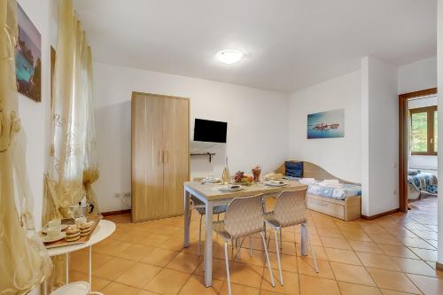a kitchen and dining room with a table and chairs at Residence La Perla with Shared Pool in Monte Isola
