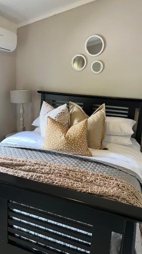 a bed with pillows on it in a bedroom at 29 Village Place in Gaborone