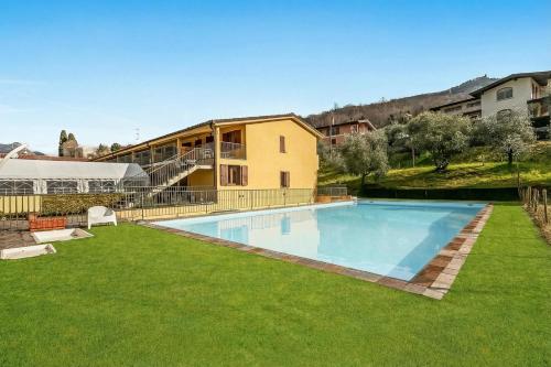 a large swimming pool in a yard next to a building at Residence La Perla with Shared Pool in Monte Isola