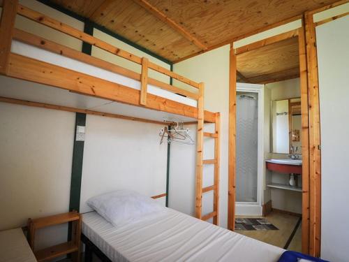 a bedroom with two bunk beds and a bathroom at Camping Onlycamp l'Astrée in Bourg-Argental