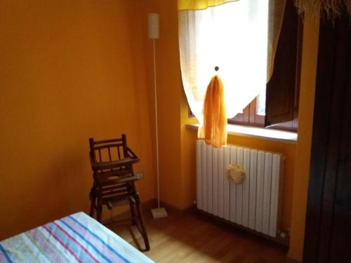 a bedroom with a bed and a window and a chair at Il Vicolo in Cagli