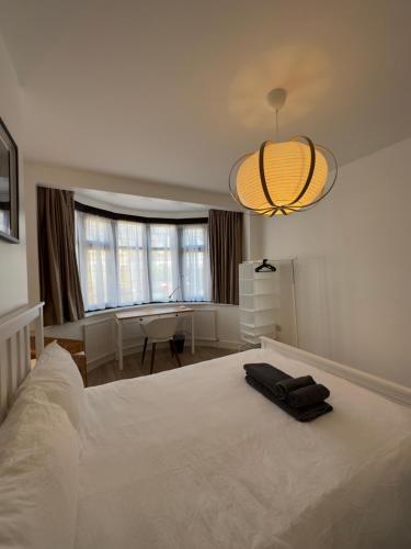 a bedroom with a large white bed and a desk at Spacious 3 Guests Ensuite Room,Piccadilly Line,Fast Access Central London 1 in London