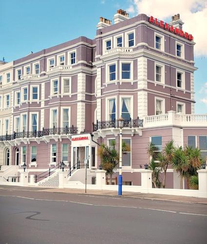 a large pink building on the side of a street at Alexandra Hotel in Eastbourne