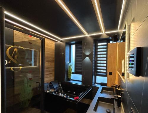 a bathroom with a sink and a mirror at Chambre business-romantique, jacuzzi, billard, clim in Verviers