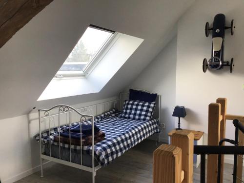 a bedroom with a bed and a window at La poésie de l'instant in Bétête