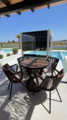 a wooden table and chairs on a patio at Villa Relax in Kallithea Halkidikis
