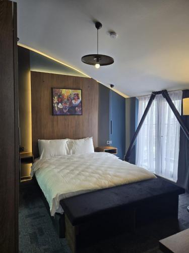 a bedroom with a large bed and a window at Loft Tepe Hotel in Dikmen