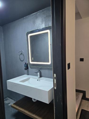 a bathroom with a white sink and a mirror at Loft Tepe Hotel in Dikmen