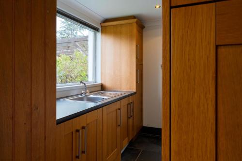 a kitchen with a sink and a window at White Sands in Croyde