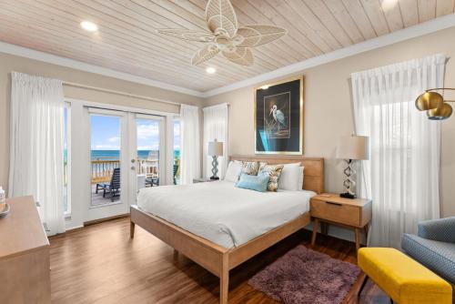 a bedroom with a bed and a living room at Pet Friendly Beachfront Home - Casa Bella Del Sol in Cape San Blas