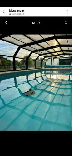 a view of a swimming pool with blue water at Gite le Martalou in Lacapelle-Viescamp