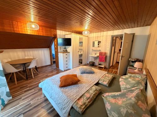 a bedroom with a large bed and a table at Wagnermoosgut in Bad Ischl