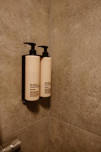 two bottles ofodorizers on a wall in a bathroom at Villa Elzenhagen in Poeldijk