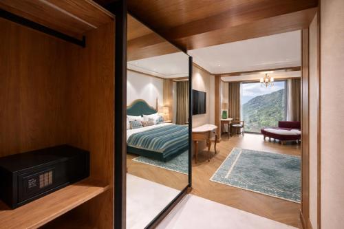 a hotel room with a view of a bedroom at AB's Abode-A Boutique Hotel in Mussoorie