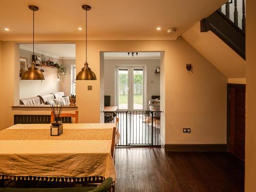 a living room with two beds and a kitchen at Sun Set House With Hot Tub in Witchford