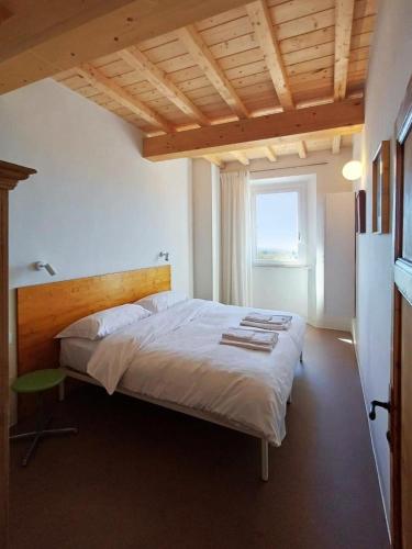 a bedroom with a large bed with a wooden headboard at Appartamenti - AL4 in Guardistallo