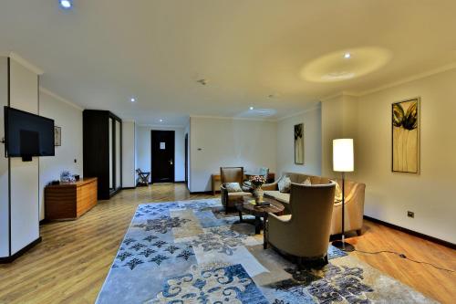 a living room with a couch and a table at Damas International Hotel in Bishkek