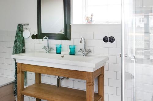 a bathroom with a white sink and a shower at Ostseehof-Kernhof in Pommerby