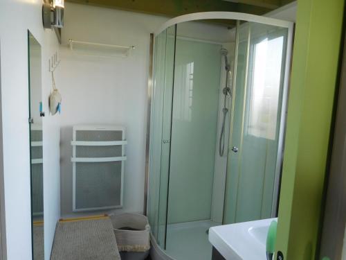 a bathroom with a glass shower and a sink at Villa Soulacaise V in Soulac-sur-Mer